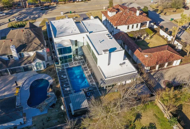 an aerial view of a house with a yard