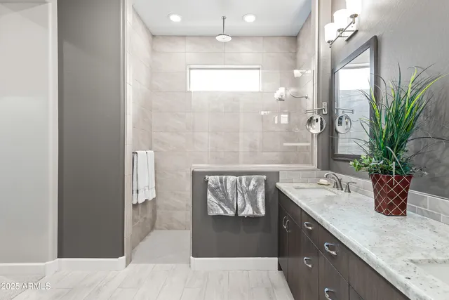a bathroom with a granite countertop sink a mirror and a shower