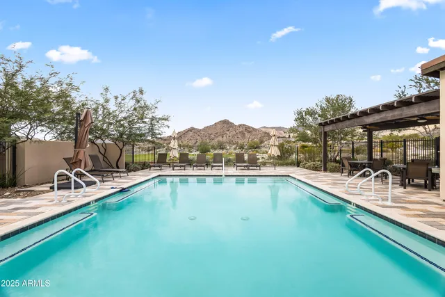 a view of a swimming pool with a lounge chair