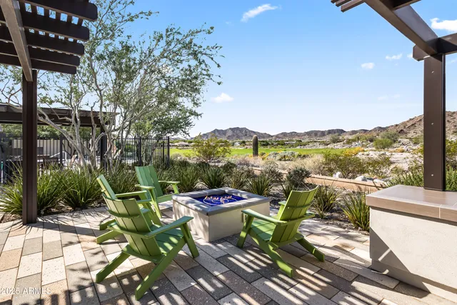 a view of a patio with a table chairs and a swimming pool