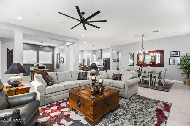 a living room with furniture a rug and a chandelier