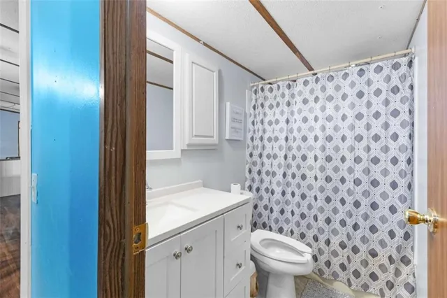 a bedroom with a bed and a painting on the wall