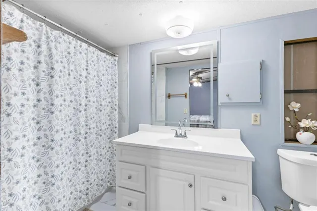 a view of a hallway with furniture and wooden floor