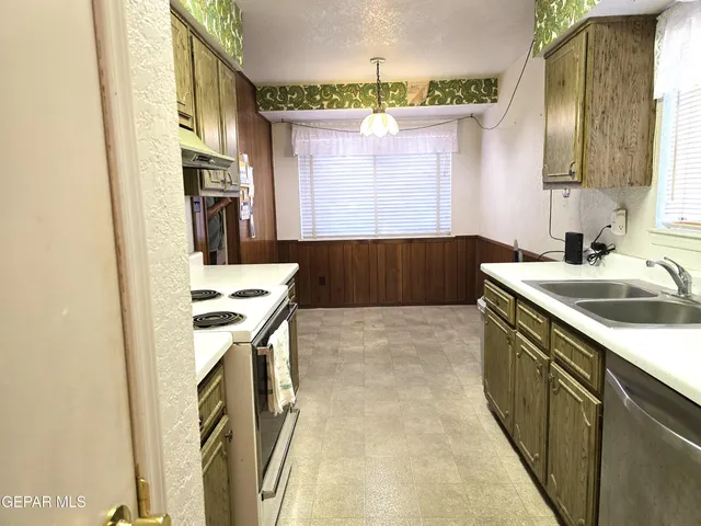 a kitchen that has a sink and a stove