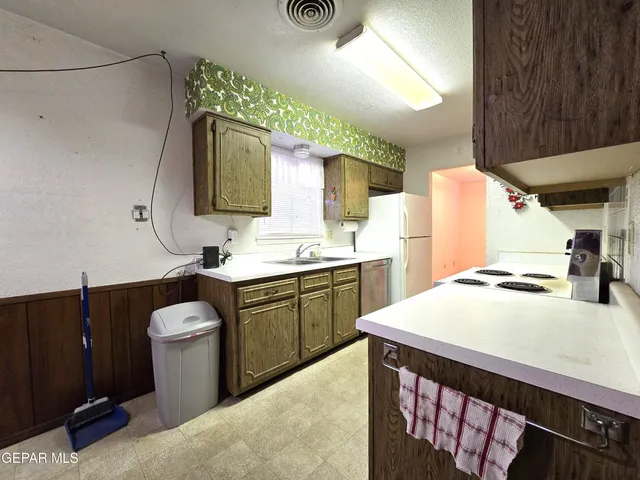 a kitchen with a sink cabinets and wooden floor