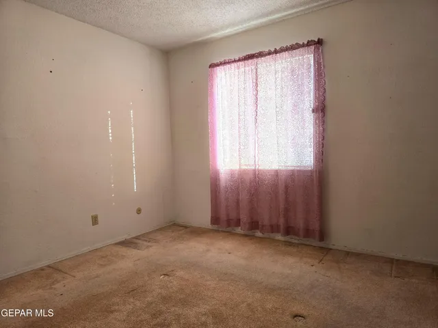 a view of an empty room and a window
