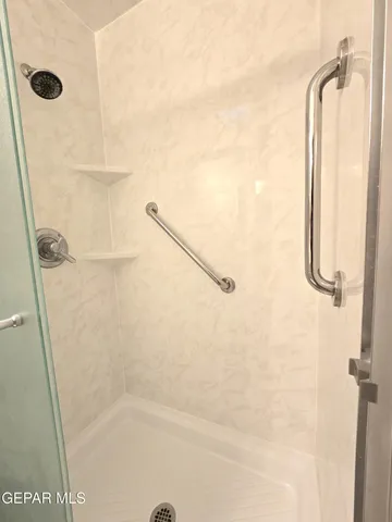 a view of empty room with window and chandelier