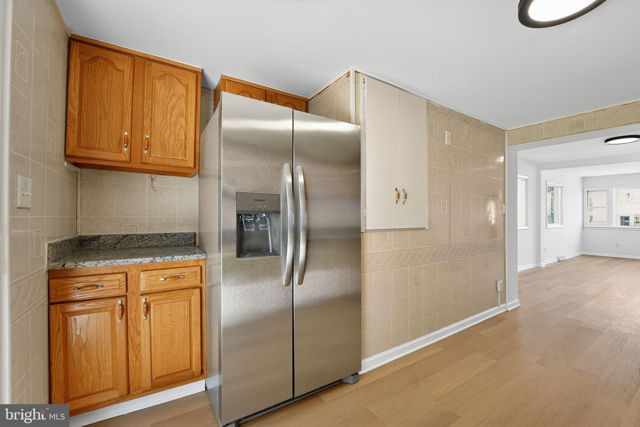 1008 Fuselage Avenue Baltimore, MD 21220 - Photo 11 of 30 a kitchen with stainless steel appliances granite countertop a refrigerator a stove and a sink with cabinets