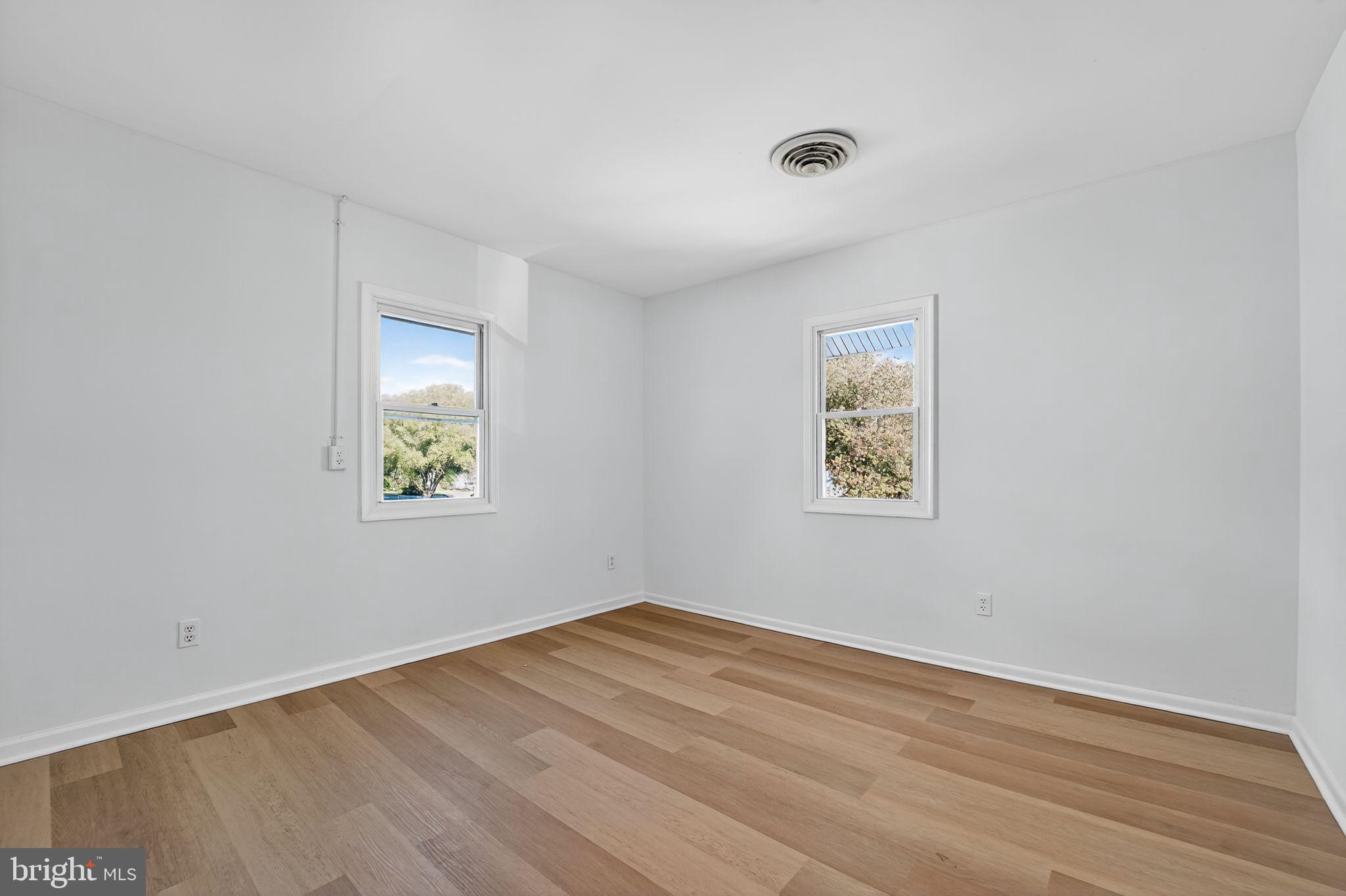 1008 Fuselage Avenue Baltimore, MD 21220 - Photo 14 of 30 a view of empty room with window and wooden floor