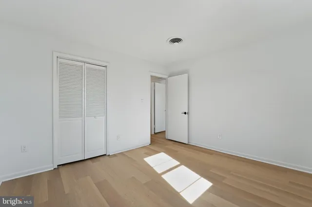 a view of an empty room and wooden floor