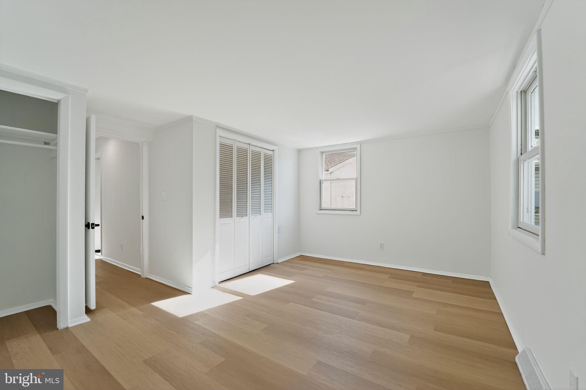 1008 Fuselage Avenue Baltimore, MD 21220 - Photo 20 of 30 a view of an empty room with wooden floor and a window