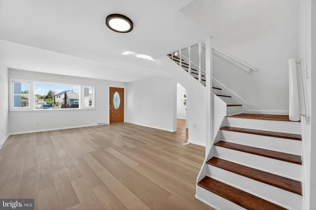 a view of entryway and hall with wooden floor