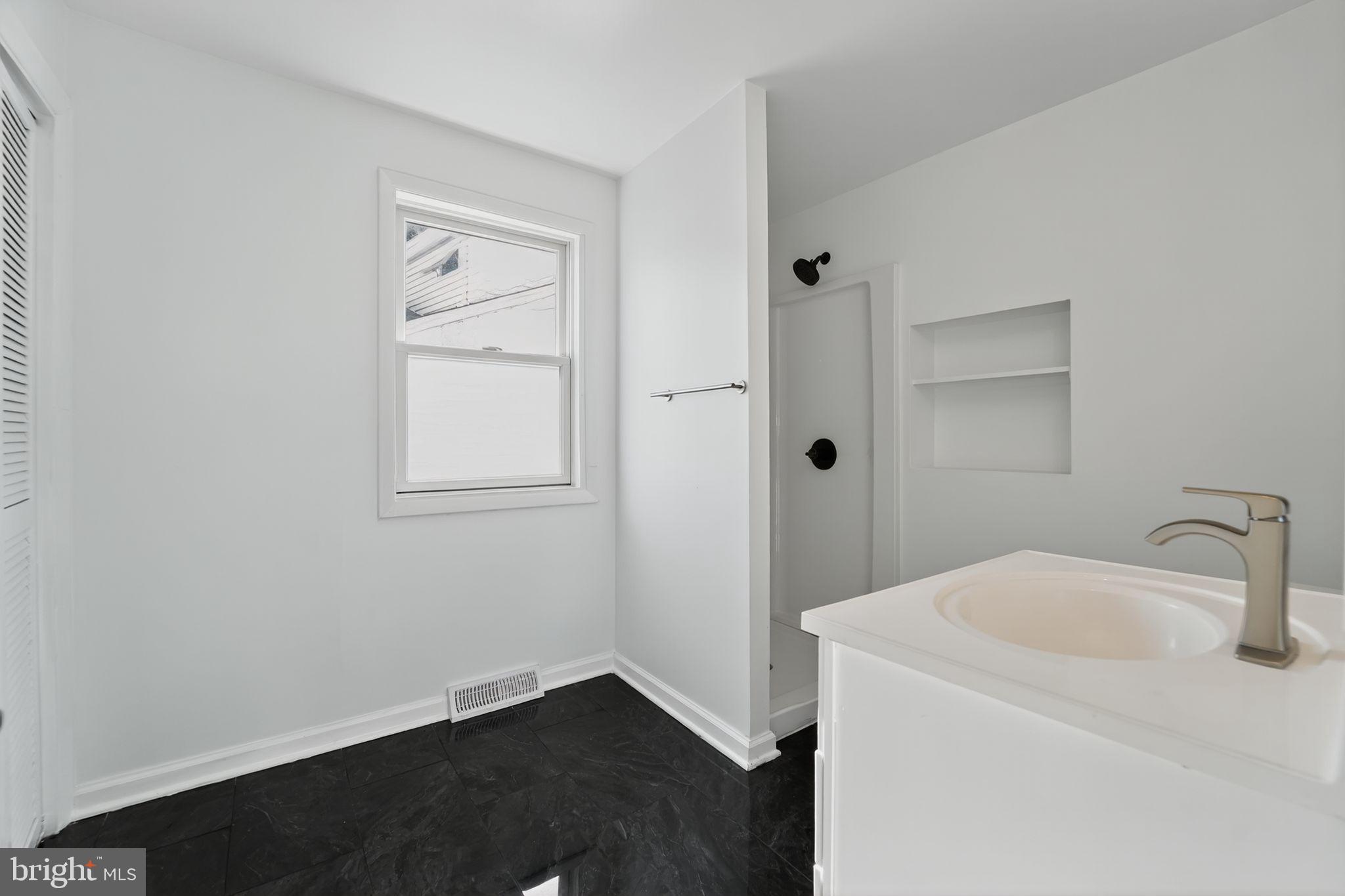 1008 Fuselage Avenue Baltimore, MD 21220 - Photo 23 of 30 a bathroom with a sink and toilet
