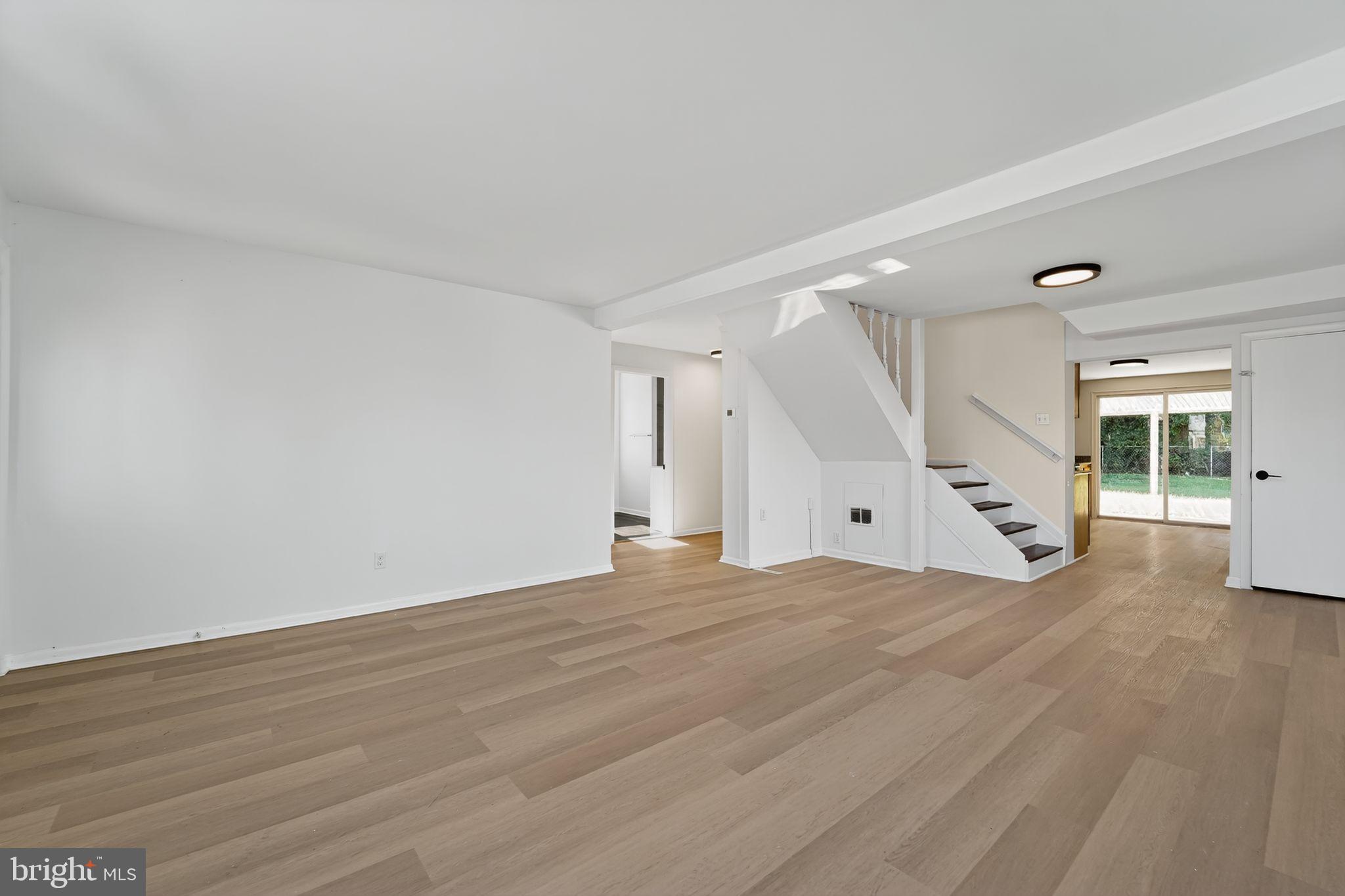 1008 Fuselage Avenue Baltimore, MD 21220 - Photo 4 of 30 a view of an empty room with wooden floor and a window