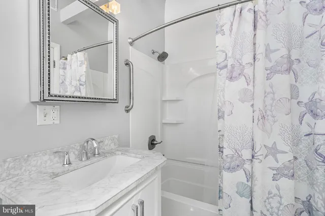 a bathroom with a granite countertop toilet sink and mirror