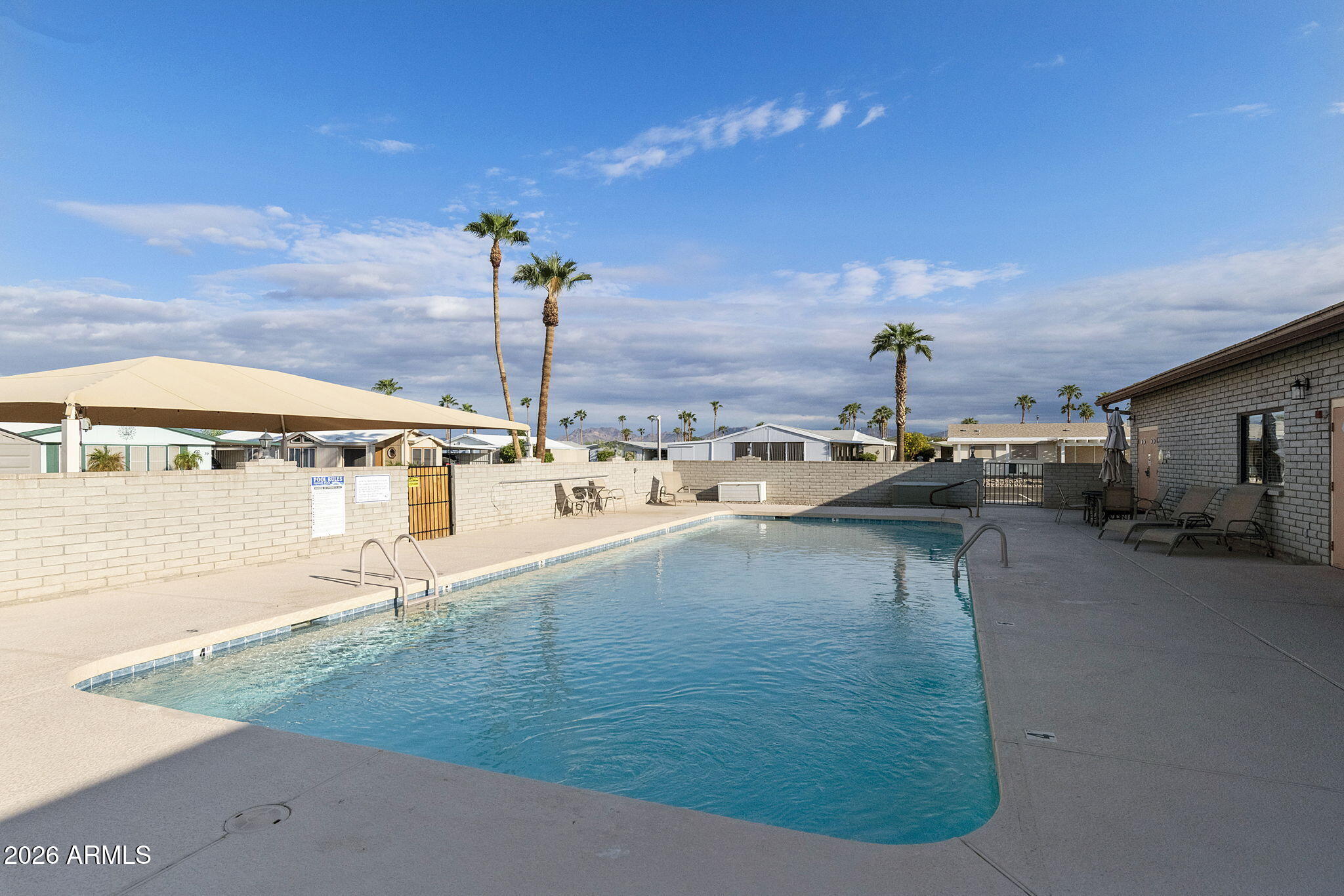 3700 South Tomahawk Road, Unit 73 Apache Junction, AZ 85119 - Photo 46 of 49 a view of a swimming pool with an outdoor seating