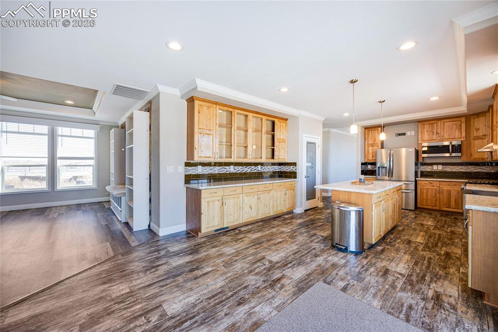 7880 J D Johnson Road Peyton, CO 80831 - Photo 8 of 50 Kitchen with decorative backsplash, hanging light fixtures, recessed lighting, crown molding, and dark wood-style floors