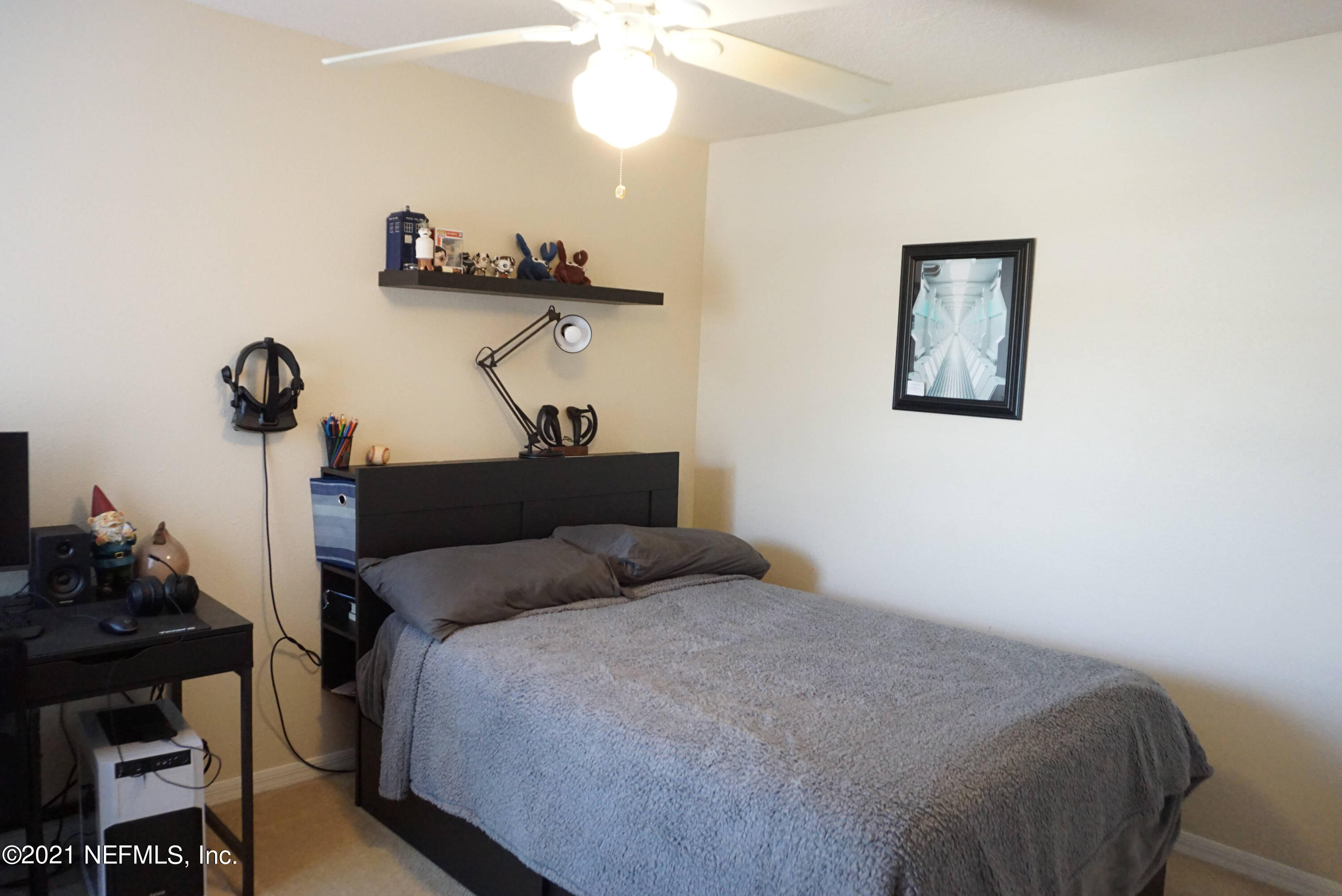 457 Cabernet Place St. Augustine, FL 32084 - Photo 11 of 19 a bedroom with a bed and a chandelier