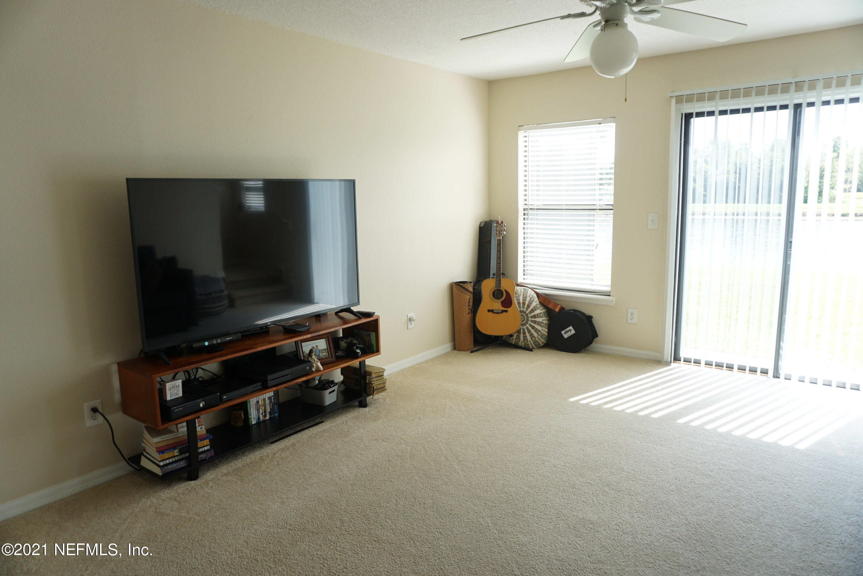 457 Cabernet Place St. Augustine, FL 32084 - Photo 4 of 19 a living room with furniture and a flat screen tv