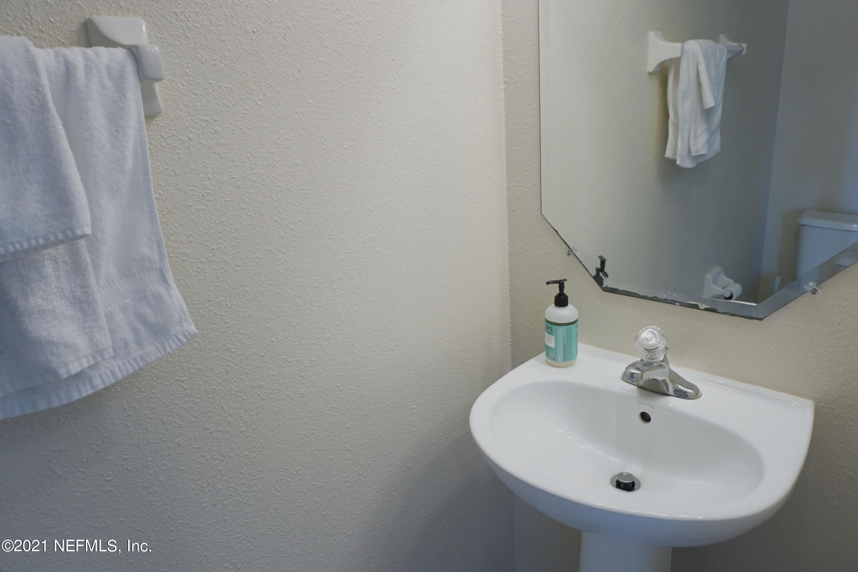 457 Cabernet Place St. Augustine, FL 32084 - Photo 8 of 19 a bathroom with a sink and mirror