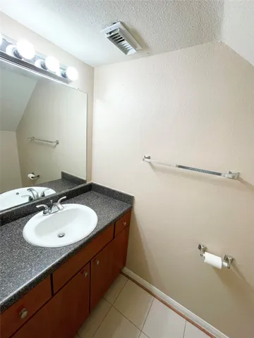 a bathroom with a sink and mirror