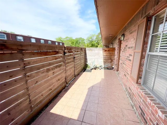 a view of balcony with wooden floor and seating space