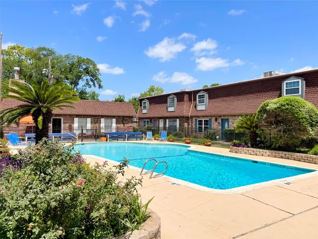a view of a house with swimming pool and a yard
