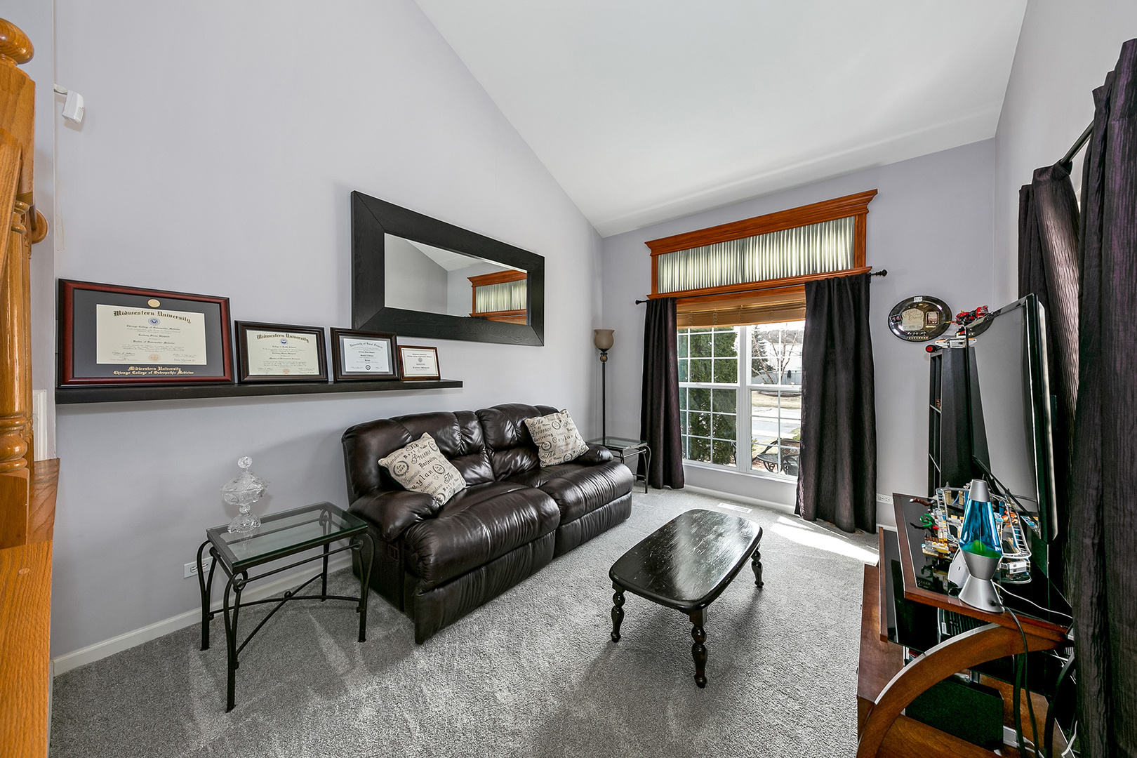 420 Butterfly Road Bolingbrook, IL 60490 - Photo 12 of 29 a living room with furniture a window and a flat screen tv