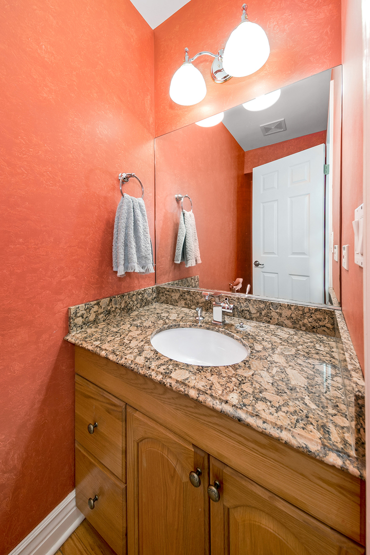 420 Butterfly Road Bolingbrook, IL 60490 - Photo 23 of 29 a bathroom with a granite countertop sink and a mirror