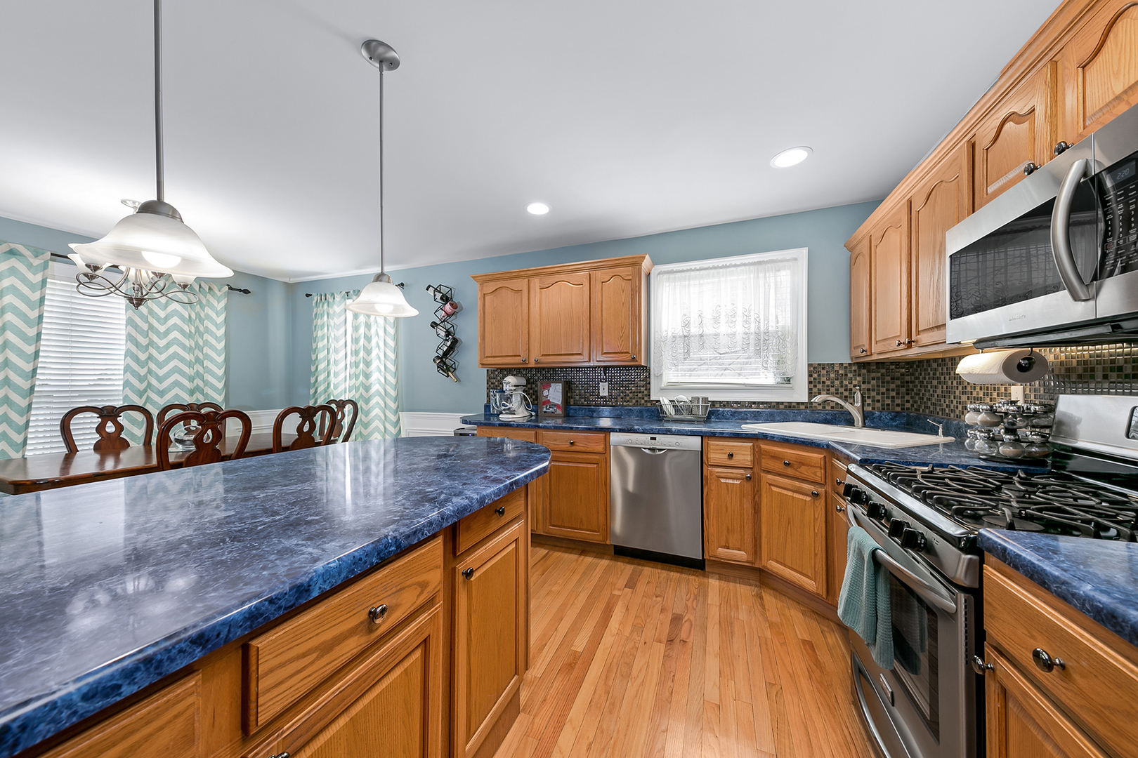 420 Butterfly Road Bolingbrook, IL 60490 - Photo 7 of 29 a kitchen with stainless steel appliances granite countertop a sink a stove top oven a counter space and cabinets
