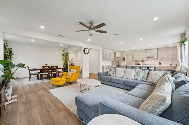 a living room with furniture a flat screen tv and a window