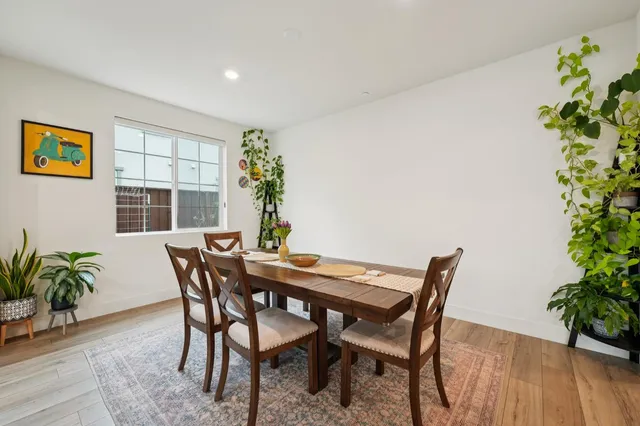 a bedroom with a bed a chair and a couch next to a window