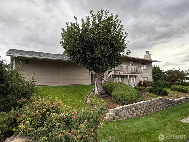 a front view of a house with a garden