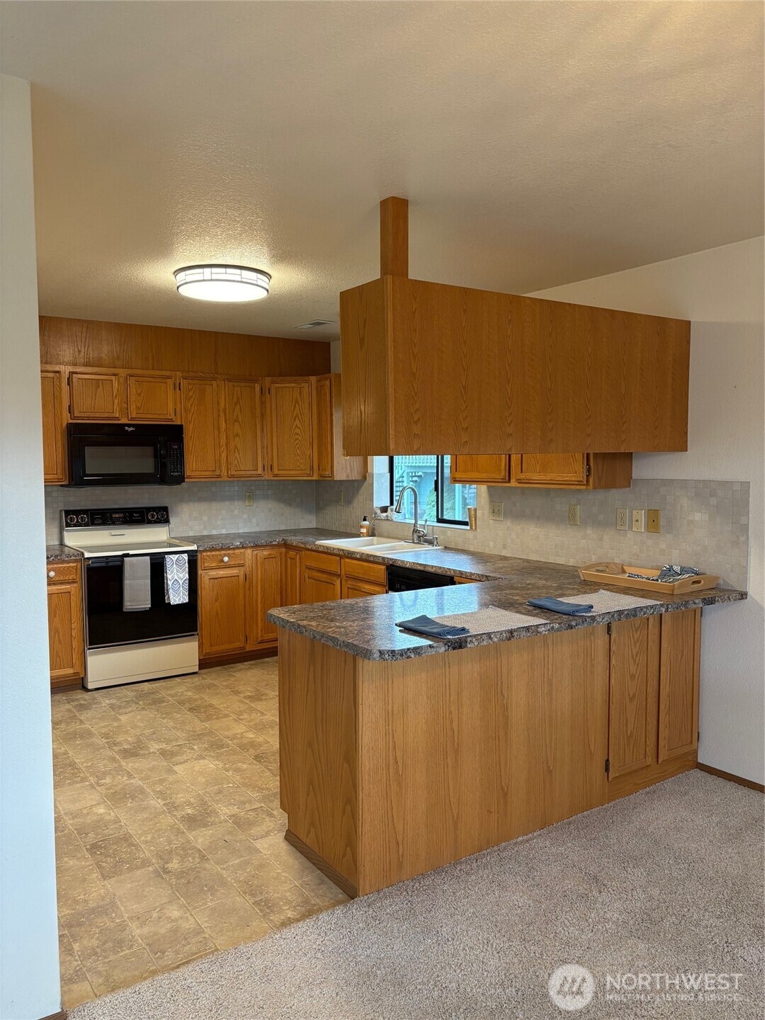 1352 Eastmont Avenue, Unit 15 East Wenatchee, WA 98802 - Photo 12 of 29 a kitchen with stainless steel appliances granite countertop a sink stove and cabinets