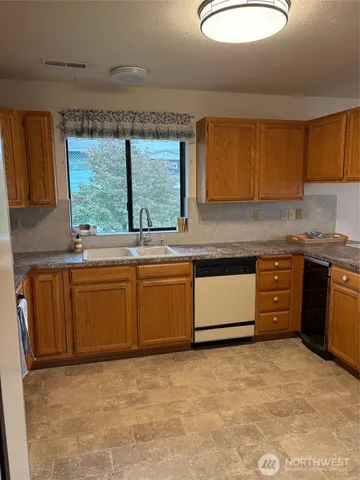 a kitchen with stainless steel appliances granite countertop a stove a sink and a granite counter tops