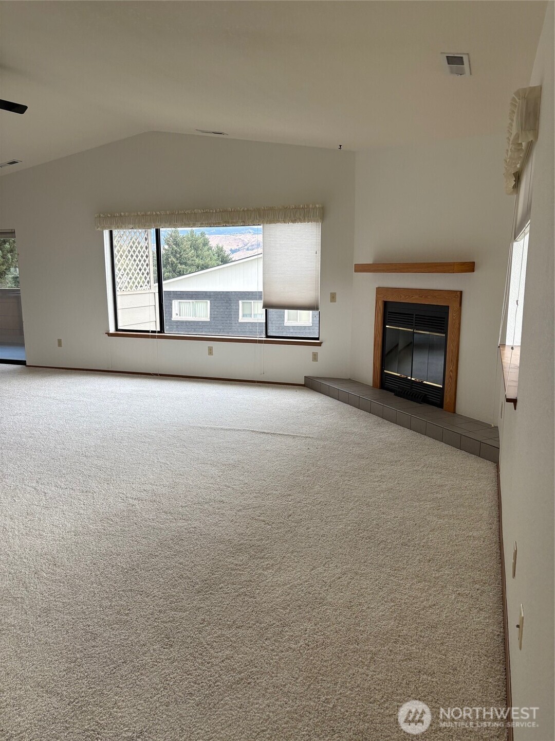 1352 Eastmont Avenue, Unit 15 East Wenatchee, WA 98802 - Photo 6 of 29 an empty room with windows and fireplace
