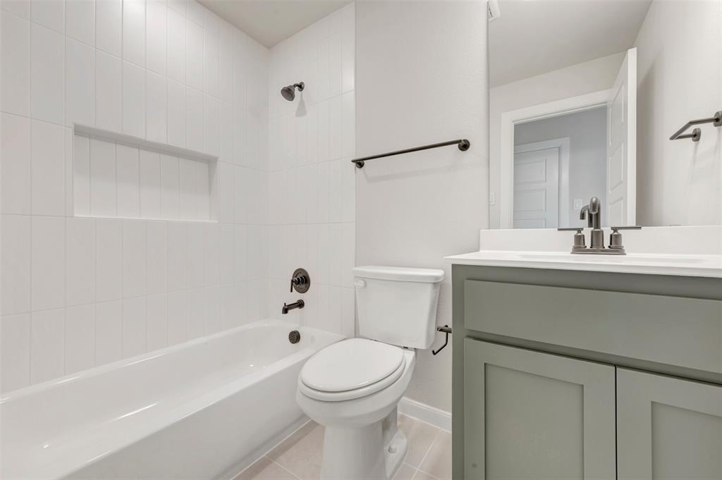 4308 Palomino Road Aubrey, TX 76227 - Photo 39 of 40 a bathroom with a sink toilet and shower