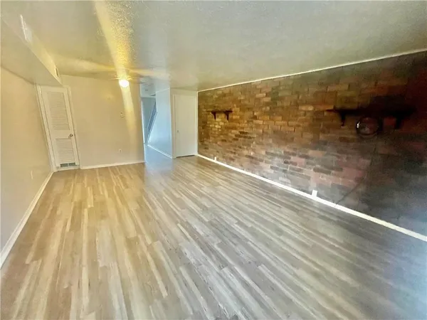 a view of an empty room and wooden floor
