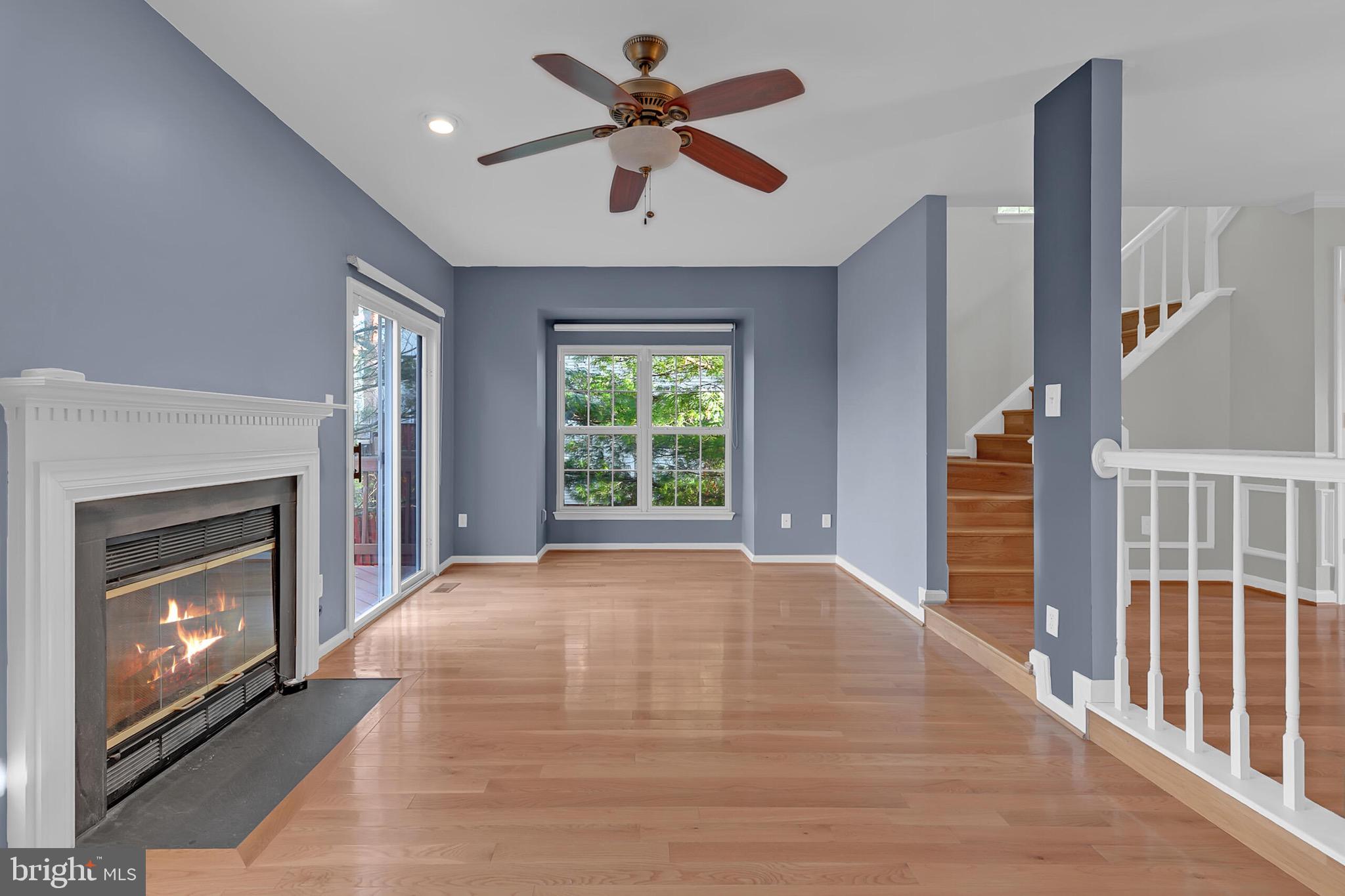 20888 Sandstone Square Sterling, VA 20165 - Photo 11 of 33 a view of an empty room with staircase fireplace and a window