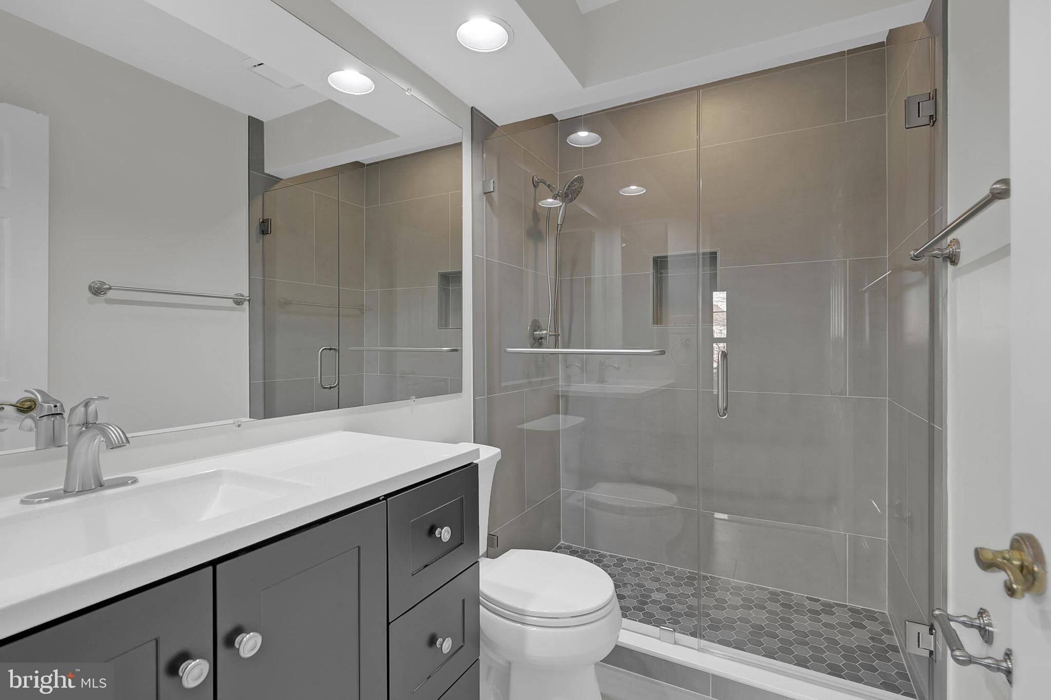 20888 Sandstone Square Sterling, VA 20165 - Photo 18 of 33 a bathroom with a sink a toilet and shower