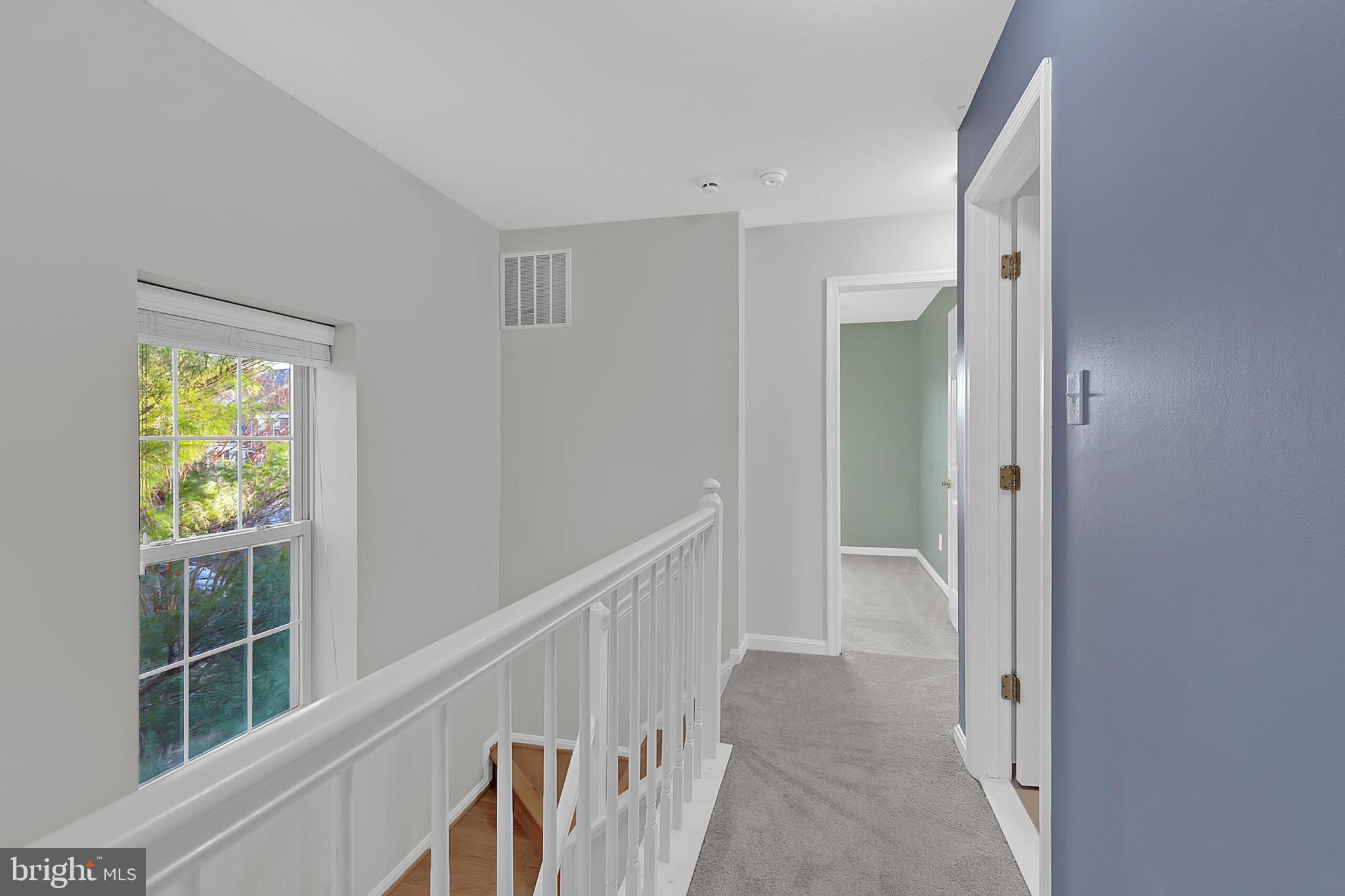 20888 Sandstone Square Sterling, VA 20165 - Photo 19 of 33 a view of hallway with wooden floor and windows