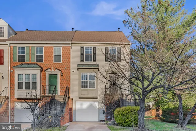 a front view of a building with a garden