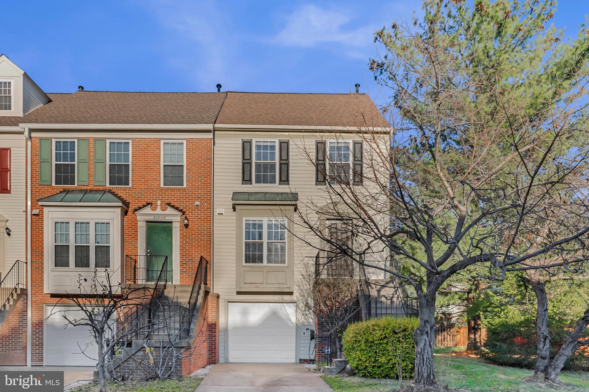 20888 Sandstone Square Sterling, VA 20165 - Photo 2 of 33 a front view of a building with a garden