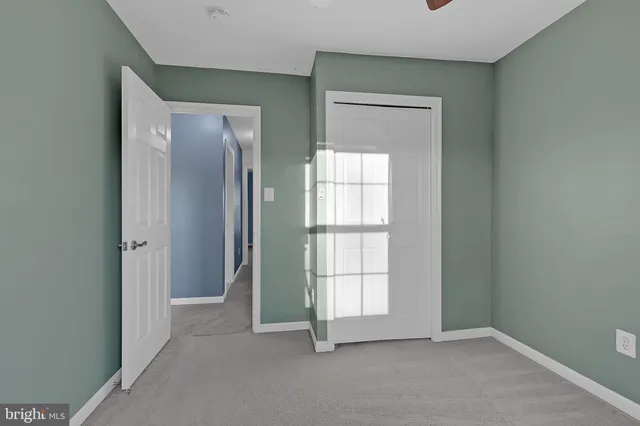 an empty room with windows and closet