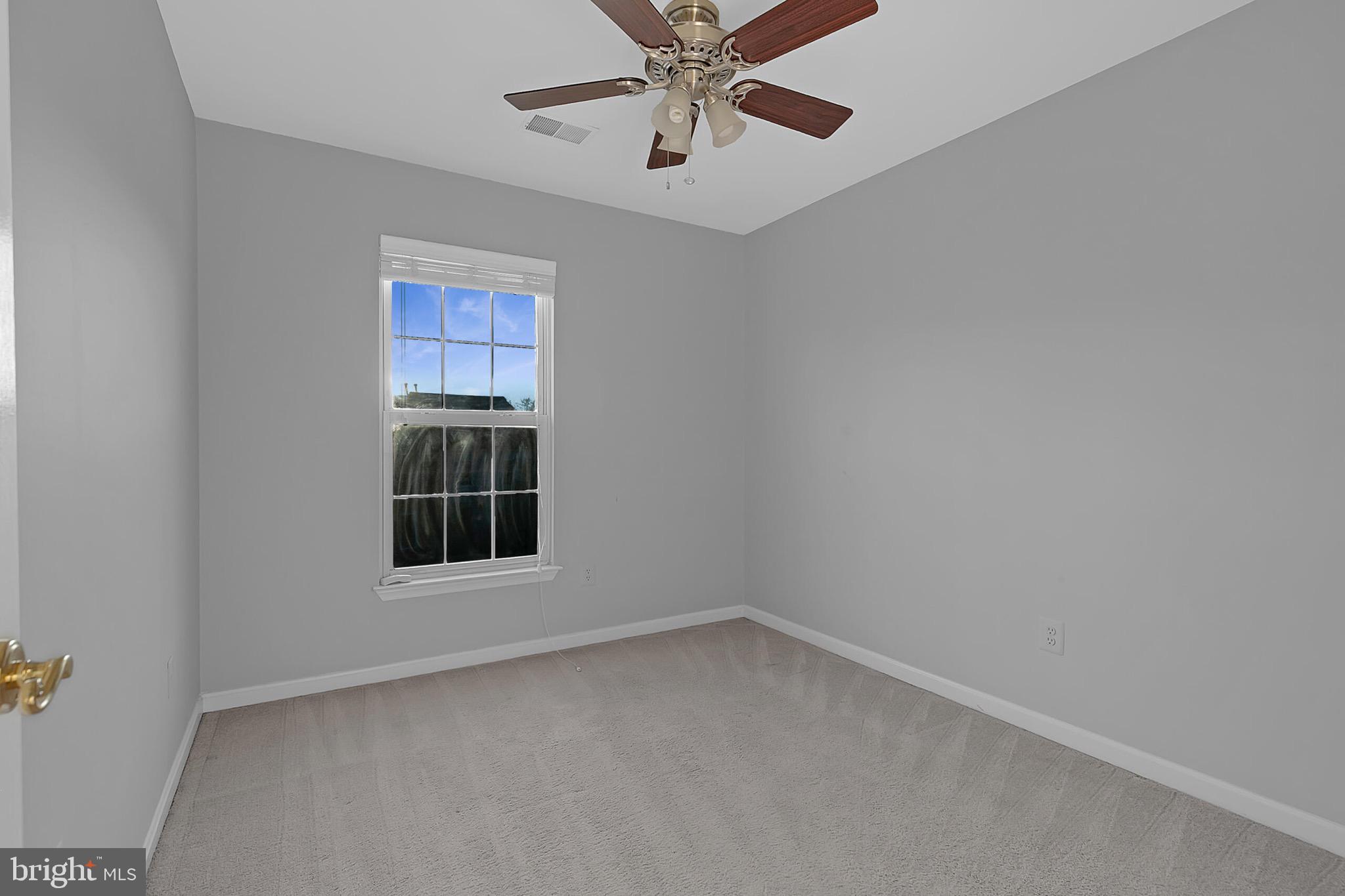 20888 Sandstone Square Sterling, VA 20165 - Photo 22 of 33 an empty room with a window and a ceiling fan
