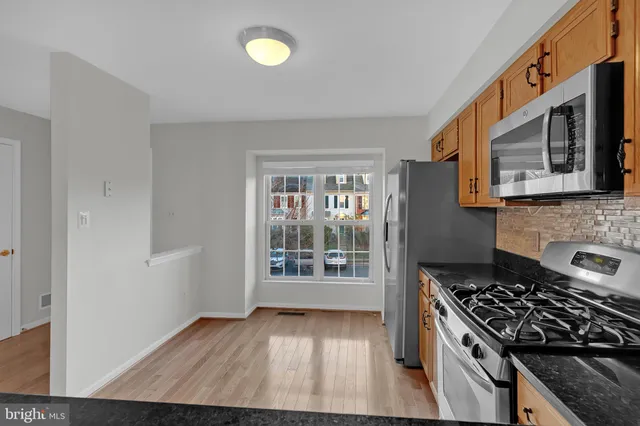 a kitchen with wooden floors and a stove