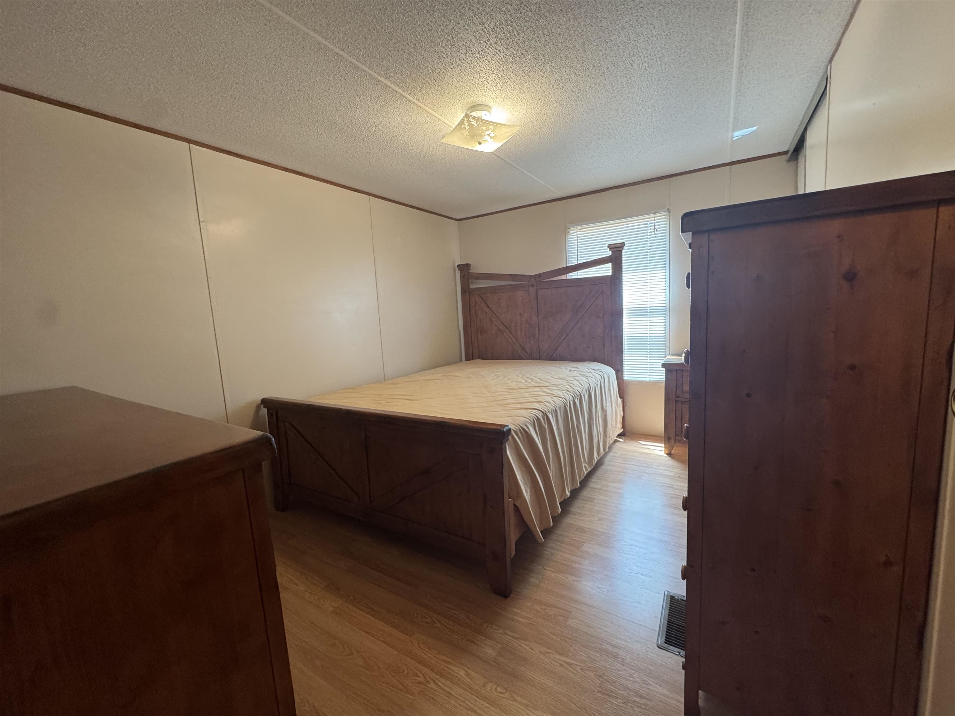 2511 Watkins Road Michie, TN 38357 - Photo 25 of 40 Spacious room with wood-finish flooring, a ceiling-mounted light fixture, and a window with blinds