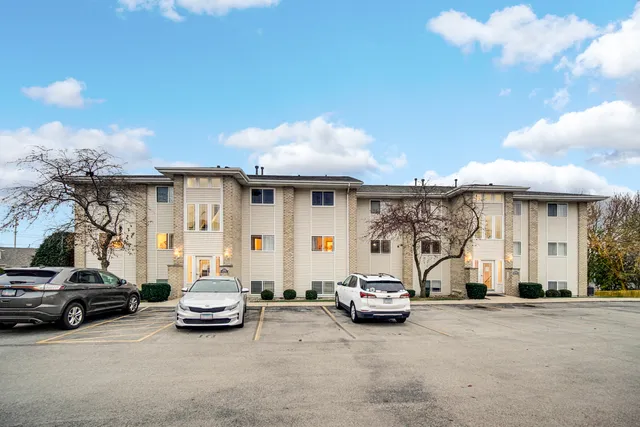 a view of a cars park in front of a house