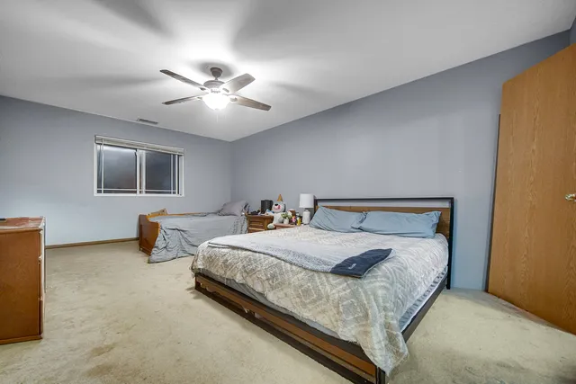 a bedroom with bed and a chandelier