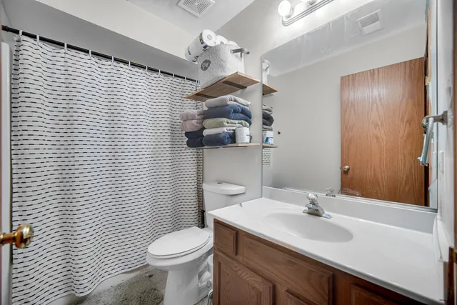 a bathroom with a sink a toilet and mirror